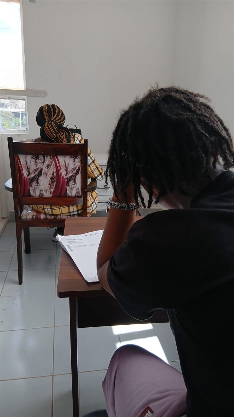 Student working with revision notes for academic progress tracking